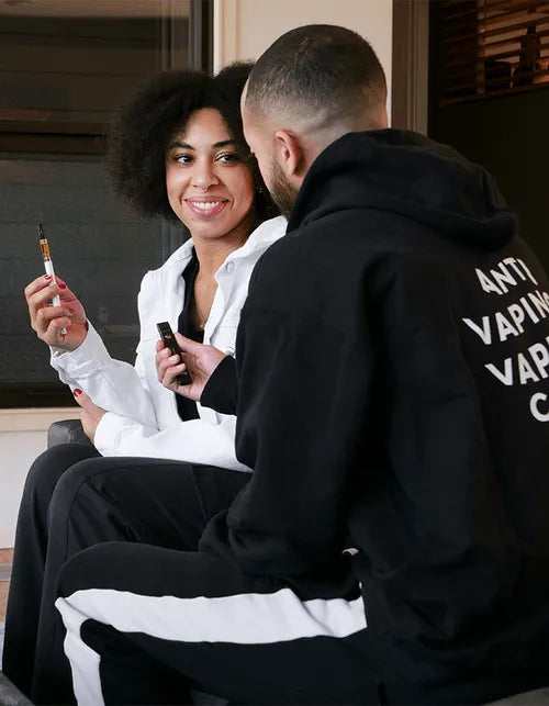 man and woman relaxing with CBD vapes