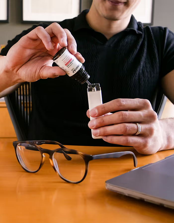 man using CBD vape juice