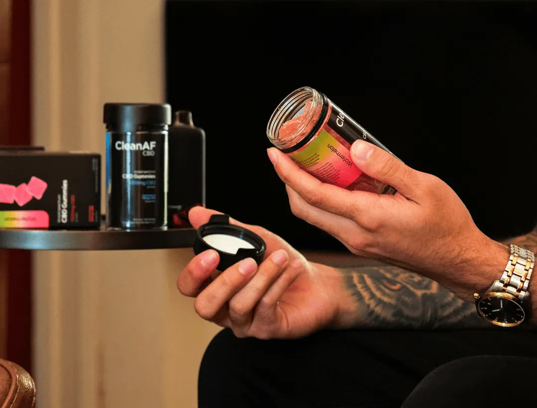 person holding THC gummies by CleanAF